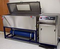 Industrial washing machine featuring a large stainless steel